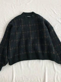green knitted sweater with check